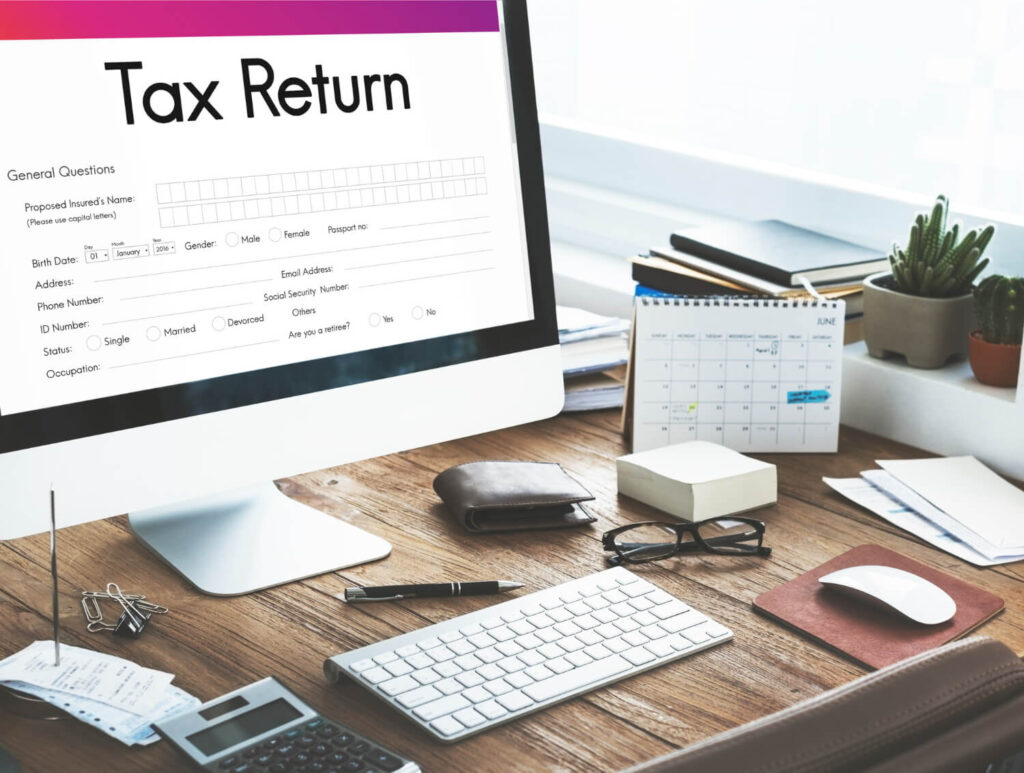 Desktop setup showing corporation tax return form and financial tools for accurate HMRC filing