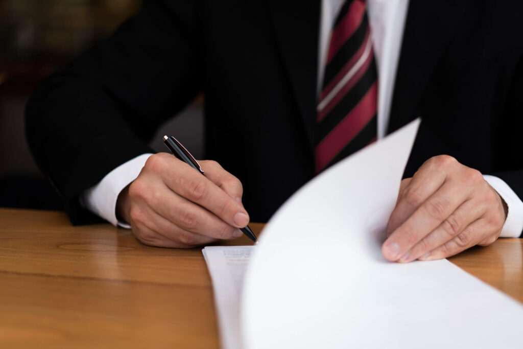 Businessman signing legal documents for appealing HMRC penalties