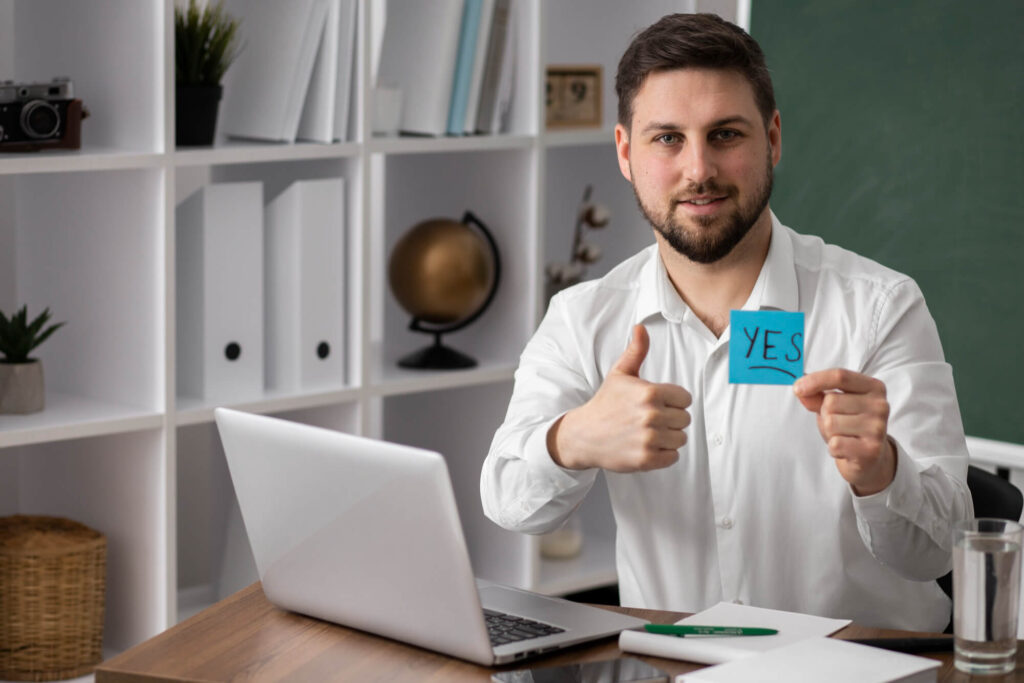 Entrepreneur celebrating self-employment registration approval in home office