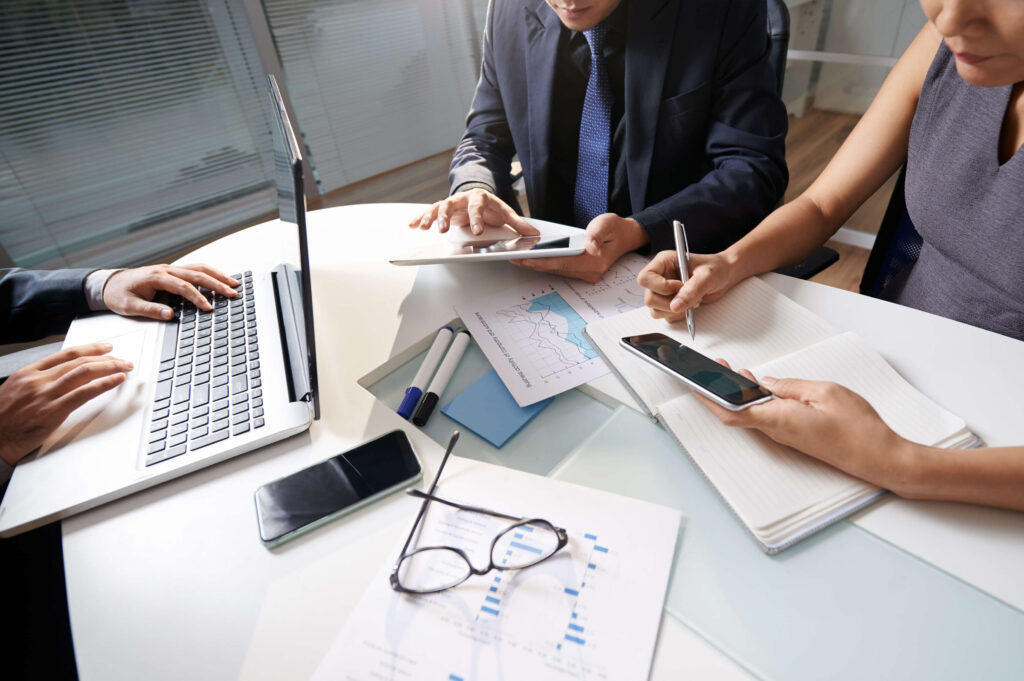 Payroll specialists reviewing employee salary reports for UK and US businesses