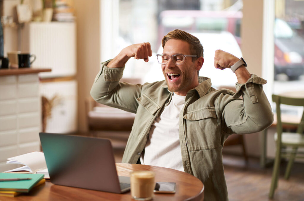 Freelancer cheering after successfully completing self-employed registration online