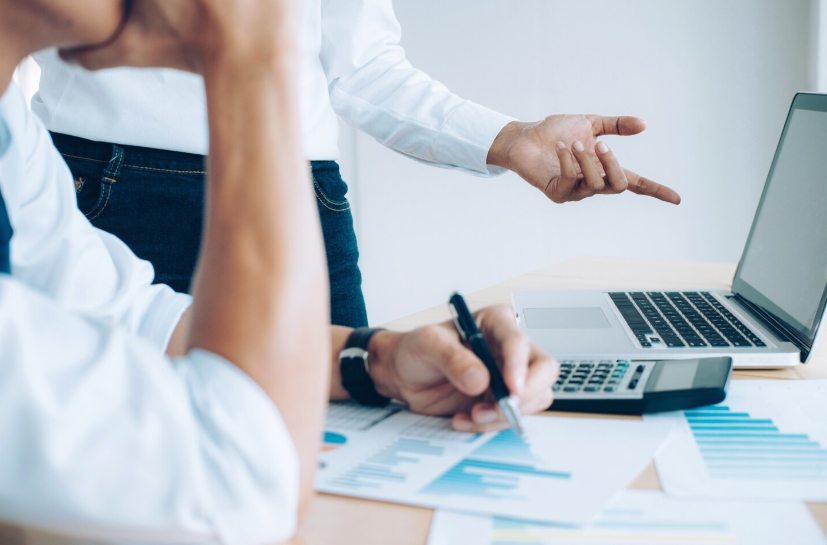 Team reviewing financial reports and job cost tracking for construction bookkeeping services – Audit Consulting Group UK