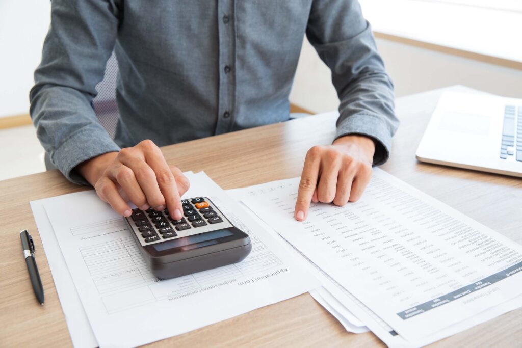 Accountant calculating financial documents and HMRC forms