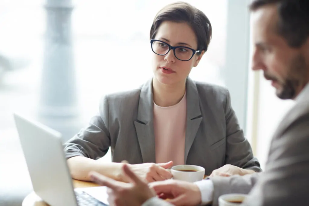 Consultant explaining tax planning to a UK or US client using a laptop