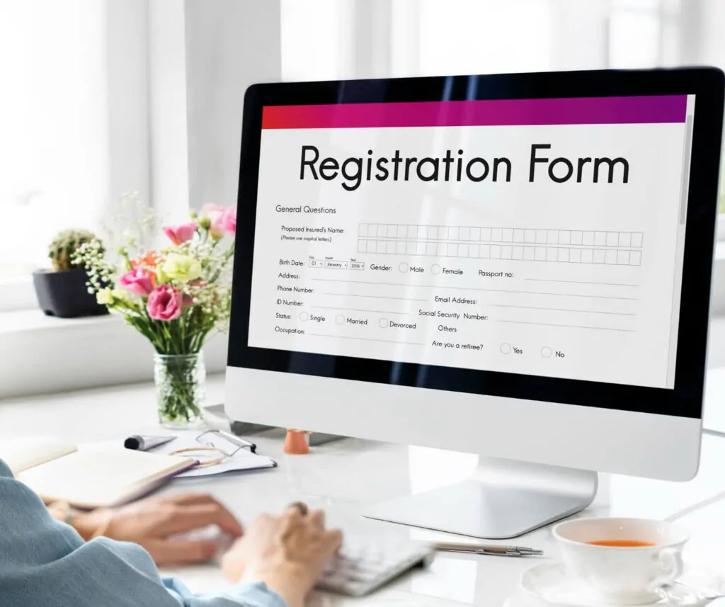Online CIS registration form displayed on a desktop screen in a modern office environment.