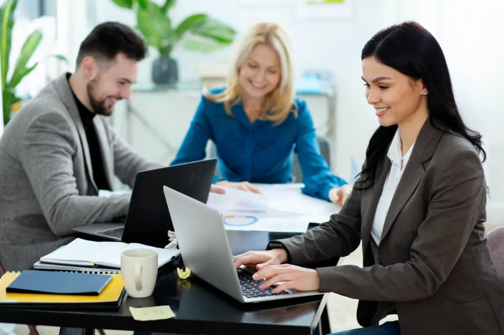 VAT submission team working together in an office, reviewing financial data and documents.