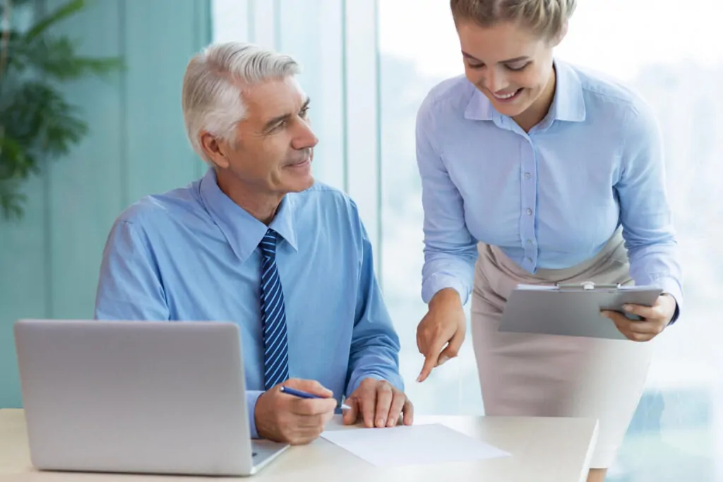 Pension advisor explaining retirement plan options to a senior client during a consultation