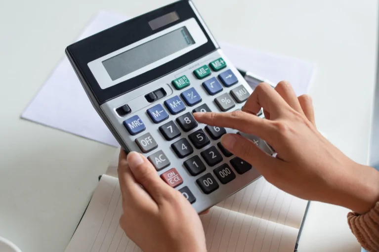 Professional small business tax accountant calculating VAT and payroll compliance in the UK | Audit Consulting Group