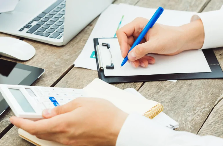 Self-employed professional reviewing expense records – Expert guidance on business expenses and tax relief by Audit Consulting Group