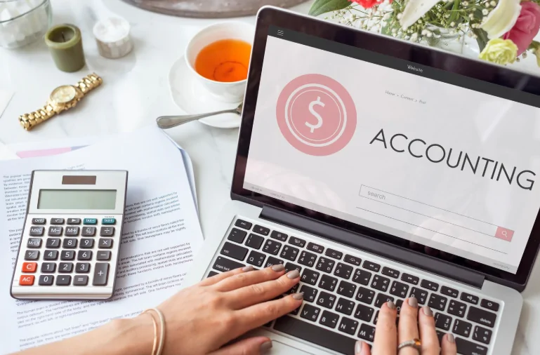 Laptop showing accounting report and calculator – Audit Consulting Group providing CIS gross payment status guidance and compliance help